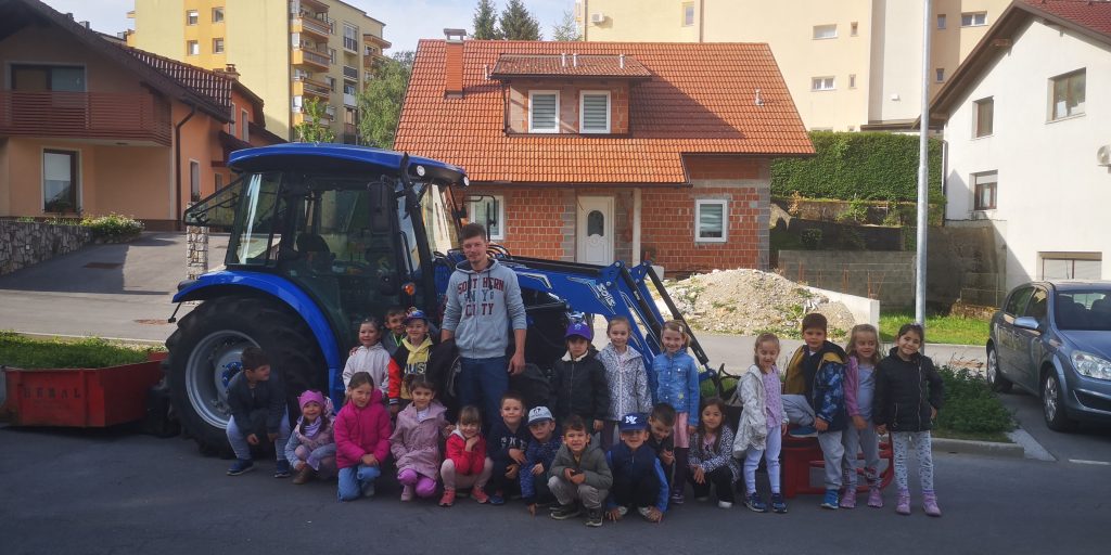 OTROCI IZ ENOTE ŠKRATEK IN VZGOJITELJ JANI Z NJEGOVIM TRAKTORJEM